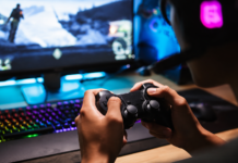 EuroGamersOnline Review 2026 Gamer using a controller on a modern PC gaming setup with RGB keyboard and monitor.